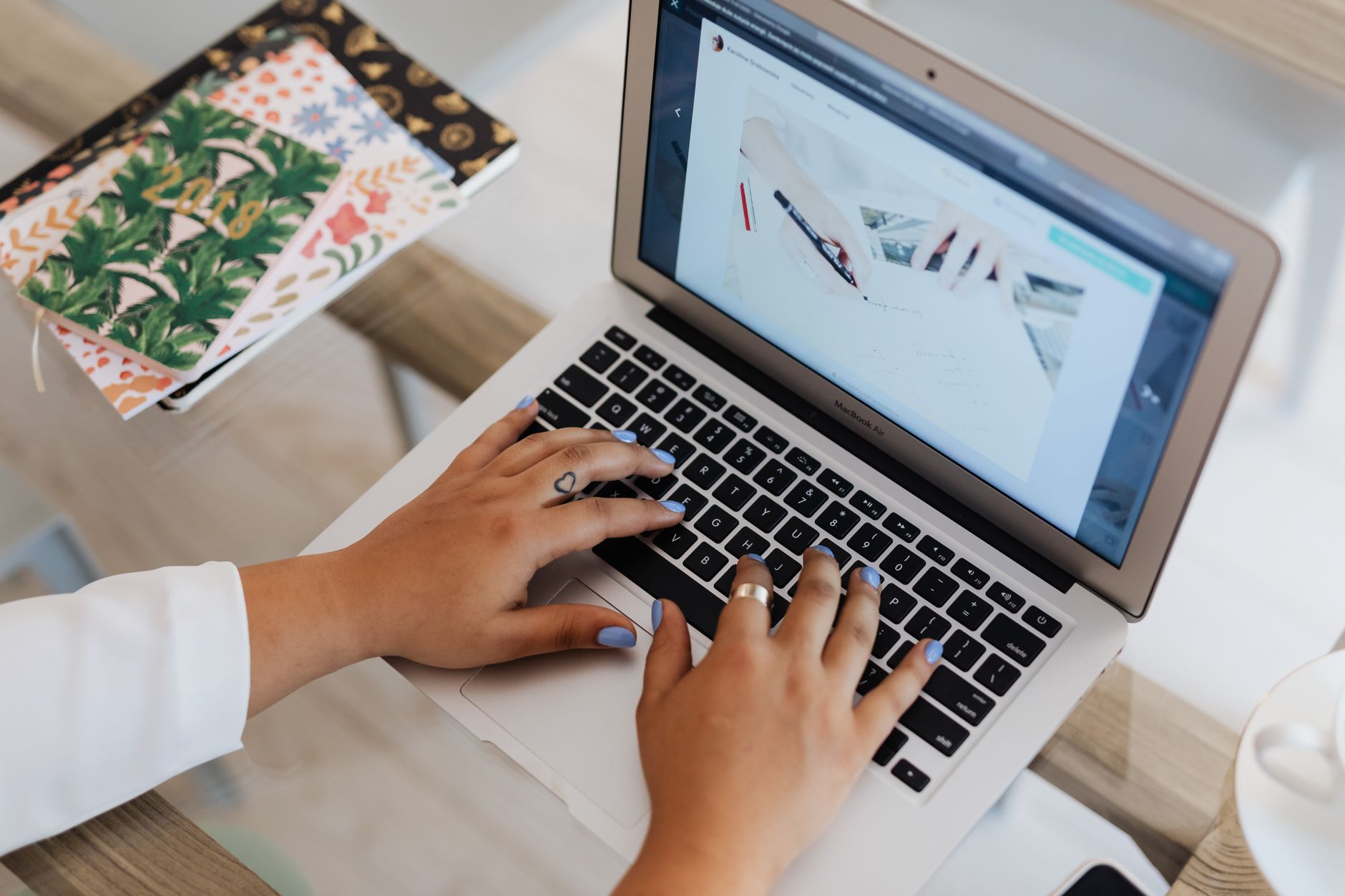 freelancer reviewing a blog draft on a laptop with a content calendar nearby