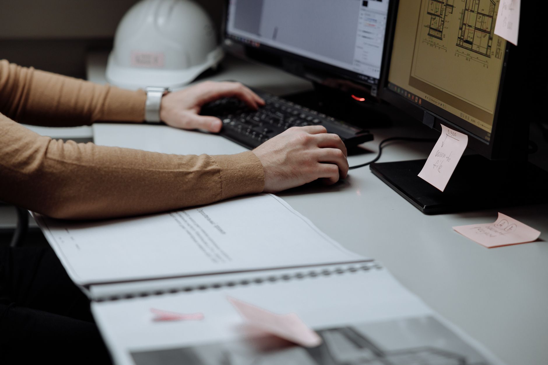 Developer working on a workflow automation builder across two computer monitors.